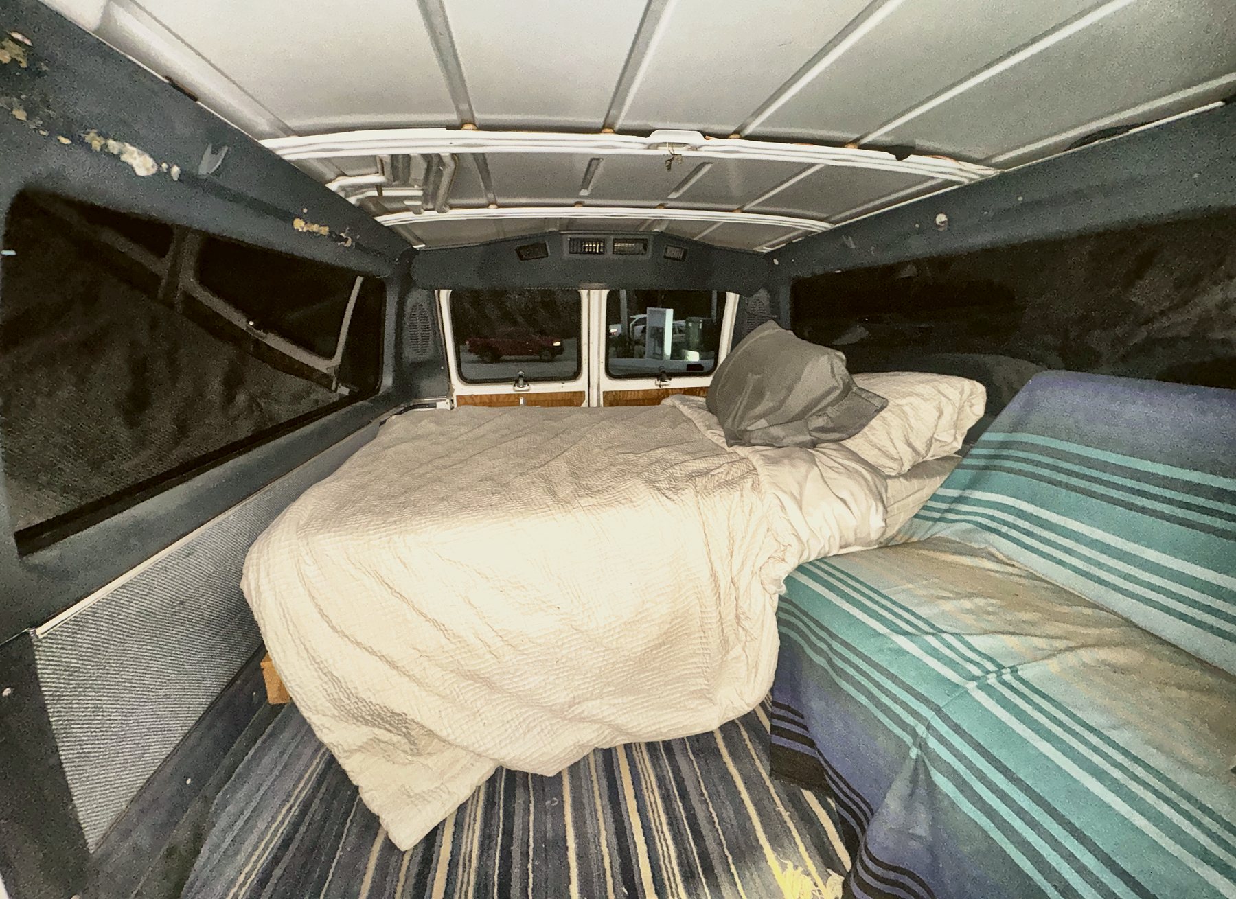 The bed in the back and the couch