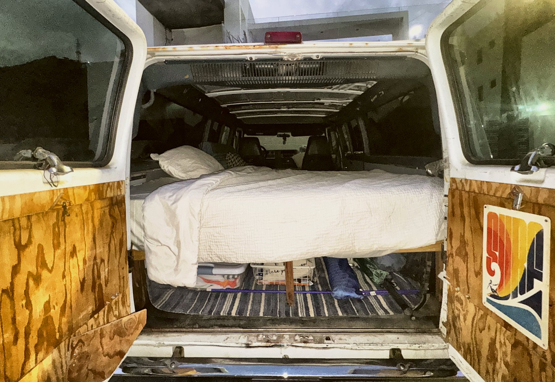 Back doors open: bed up top, gear underneath